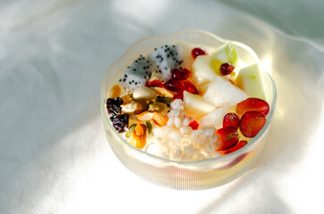 Homemade yogurt topped with sauce, fresh fruit and lots of grains.