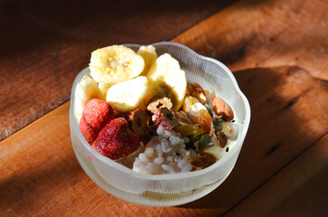 Homemade yogurt topped with sauce, fresh fruit and lots of grains.