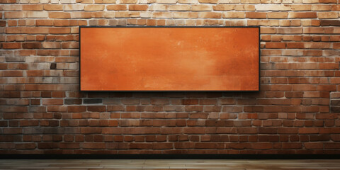 Empty orange canvas hanging on a textured brick wall, ideal for background or mockup in interior...