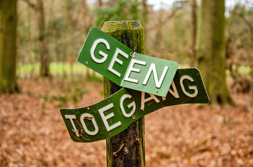 Oostvoorne, The Netherlands, December 23, 2023: twisted and distorted sign in a forest with the...