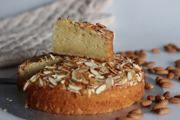 Sliced almond buttermilk cake. A delicious cake adorned with a generous sprinkle of chopped almonds, perfect for tea time