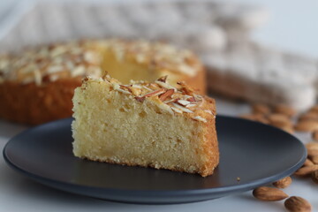 Sliced almond buttermilk cake. A delicious cake adorned with a generous sprinkle of chopped almonds, perfect for tea time