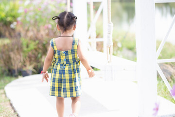 A young woman sits on a swing and admires the breathtaking view of beautiful nature.