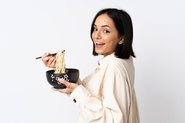 Young caucasian woman isolated on white background holding a bowl of noodles with chopsticks