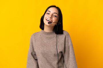 Young telemarketer woman isolated on yellow background laughing - obrazy, fototapety, plakaty
