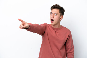 Young handsome Brazilian man isolated on white background pointing away