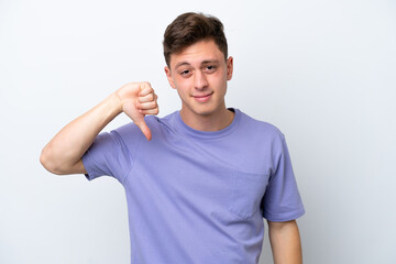 Fototapeta premium Young handsome Brazilian man isolated on white background showing thumb down with negative expression