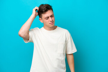 Young handsome Brazilian man isolated on blue background having doubts while scratching head