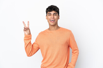 Young man over isolated white background smiling and showing victory sign