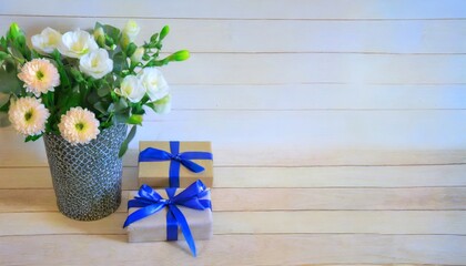 beautiful flowers and gift boxes on light background
