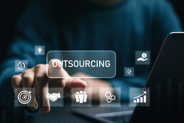 Outsourcing concept, Businessman use laptop with outsourcing word on virtual screen. Human...