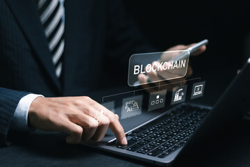 Businessman using laptop with blockchain icon in hand for blockchain industry 4.0 technology on...