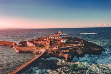 Naklejka premium Aerial view of Tapia Island in Tapia de Casariego, a beatiful lighthouse in Asturias, Spain.