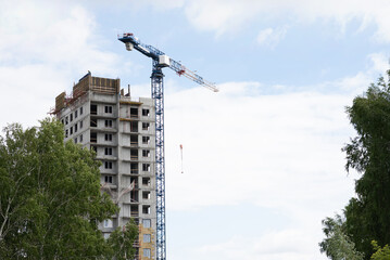 Fototapeta premium A construction crane on a blue sky background.