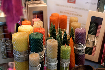 Composition with handmade wax candles, reed diffuser and fruits on color background