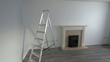 Decorating the house, step ladder in lounge after walls have been painted with a fresh coat of white emulsion