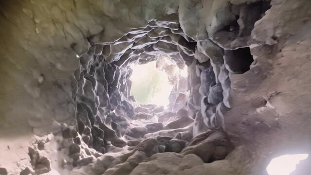 Bizarre surrealistic descent from a well made of old stones inside the underlying cave. Bid farewell to the open and delve deep into Earth's viscera.

