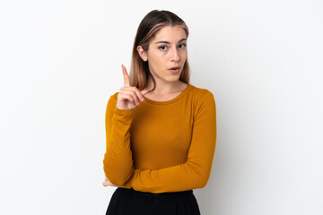 Young caucasian woman isolated on white background intending to realizes the solution while lifting a finger up