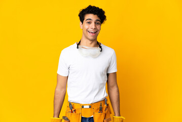 Venezuelan electrician man isolated on yellow background with surprise facial expression