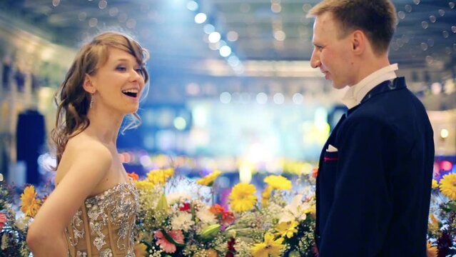 Happy beautiful young couple near flowers at fandango