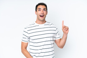 Young caucasian man isolated on white background pointing up and surprised