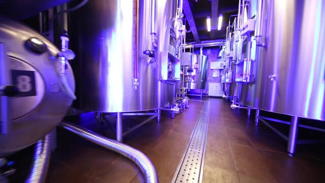 Moving between rows of tanks in microbrewery.