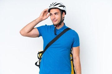 Young caucasian man with thermal backpack isolated on white background having doubts and with confuse face expression