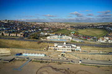 Aerial view of the Saltdean art deco Lido and the WhiteCliffs Saltdean Cafe on the seafront in East Sussex England with the South Downs in the background.