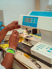 close up of adult black seamstress desginer hands use sewing machine to sew a shirt with precision care
