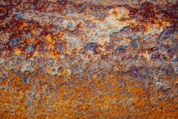 Red rust and corrosion on a steel sheet, close-up. Abstract metal grunge background.