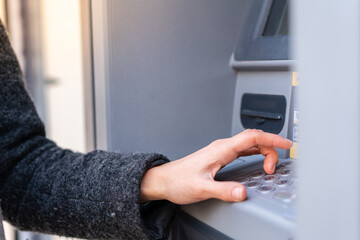 Brunette woman holding a credit card at outdoors