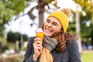 Brunette woman with a cornet ice cream at outdoors