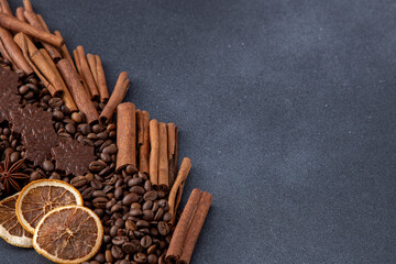 Food background. Coffee beans, cinnamon sticks, anise stars and chocolate candies top view. Copy space