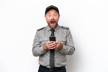 Middle age security man isolated on white background surprised and sending a message