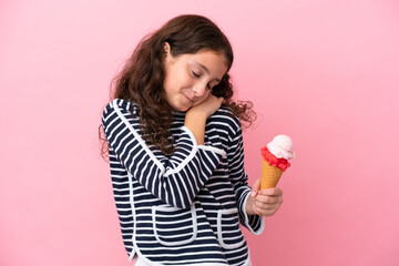 Little caucasian girl holding an ice cream isolated on pink background suffering from pain in...