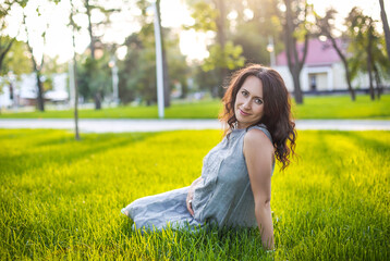 Pregnant woman resting on lawn