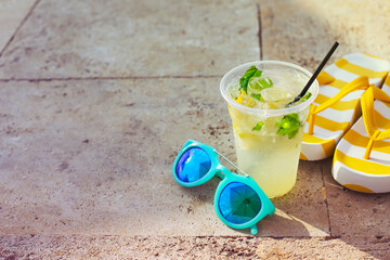 Sunglasses, flipflops and mojito glass