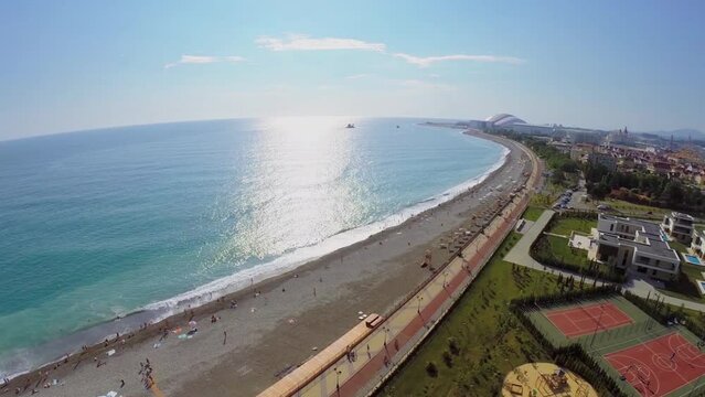 Sea beach near territory of hotels with sports playgrounds