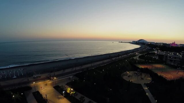 Sea beach with people get rest near territory of hotel