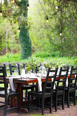 Decoration of wedding table with crystal vases, flowers and branches in botanical style