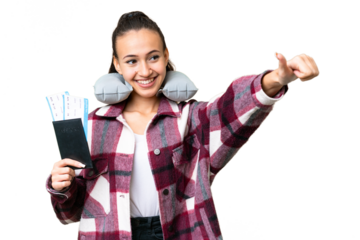 Young Traveler woman holding a passport over isolated chroma key background giving a thumbs up gesture