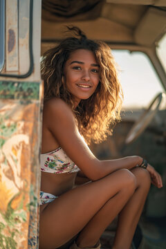 Happy smiling hippie woman sitting inside vintage camper van