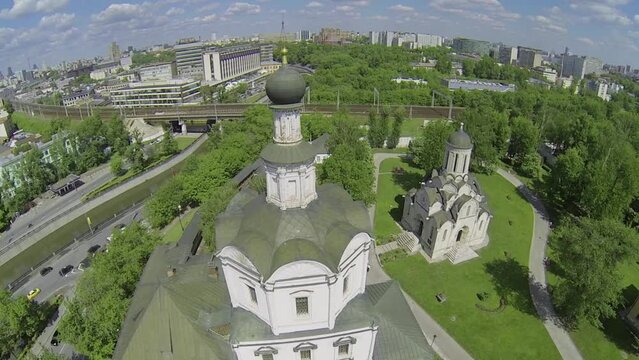Spaso-Andronikov monastery against cityscape with traffic on quay