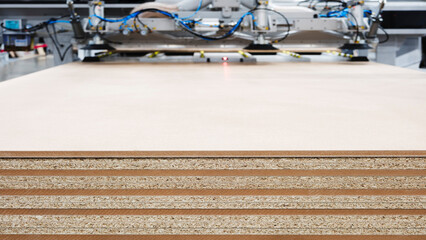 Wood boards on a woodworking machine in a modern furniture factory, woodworking industrial concept background