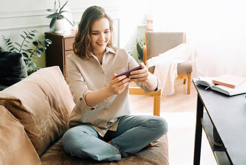 Woman Embracing Digital Connection. Reading Messages, Socializing on Social Media, and Playing Mobile Games on Smartphone Happy Young Female Engaging in Modern Digital Communication and Entertainment.