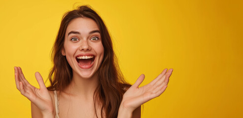 Young girl with hands up yellow background