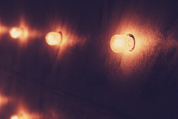 Light bulbs on the wall in the dark, vintage style, retro