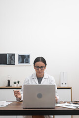 Virtual Healthcare Provider: Engaged in a laptop-based consultation, a female doctor exemplifies...