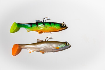 Fishing tackle on a white background. Top view. colorful silicone fish lures with hooks fishing...