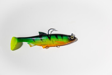 Fishing lure on a white background. colorful silicone fish bait with a hook isolated on white background cut out top view © Yelena